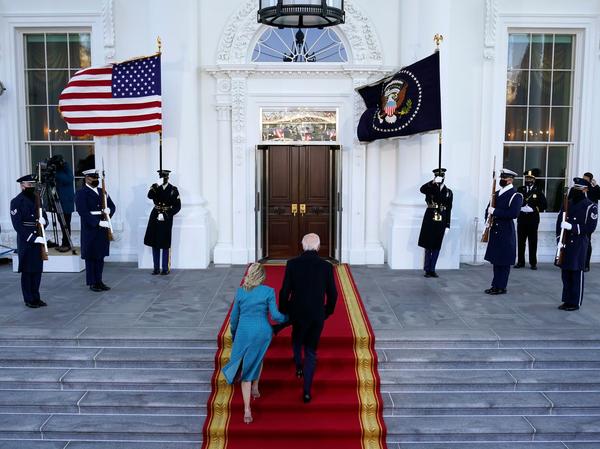 President Biden and first lady Jill Biden walk up the stairs as they arrive at the North Portico of the White House on Wednesday.
