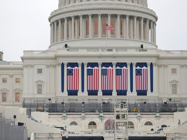Wednesday's inauguration, coming two weeks to the day after the insurrection on the Capitol, will be unlike any other in living memory, writes NPR's Michel Martin. Above, the Capitol building is seen as workers prepare for the inauguration ceremony for Barack Obama in 2013.