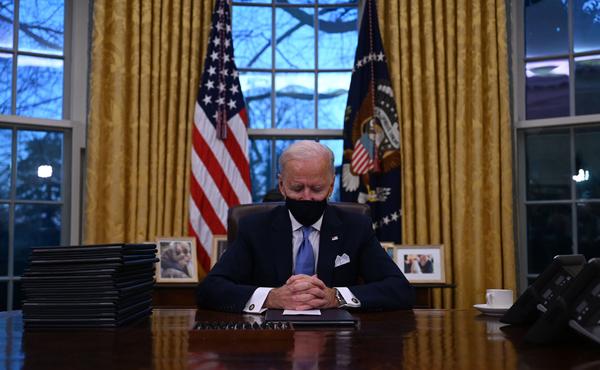 President Biden sits in the Oval Office at the White House after being sworn in as the 46th president of the United States on Wednesday.