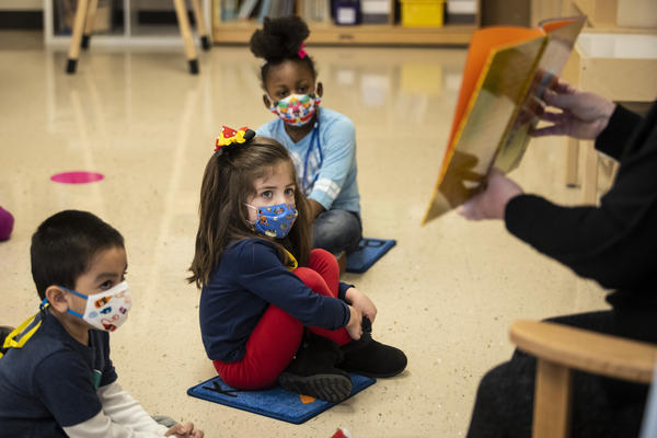 Prekindergarten students listen as their teacher reads a story this month at Dawes Elementary School in Chicago.