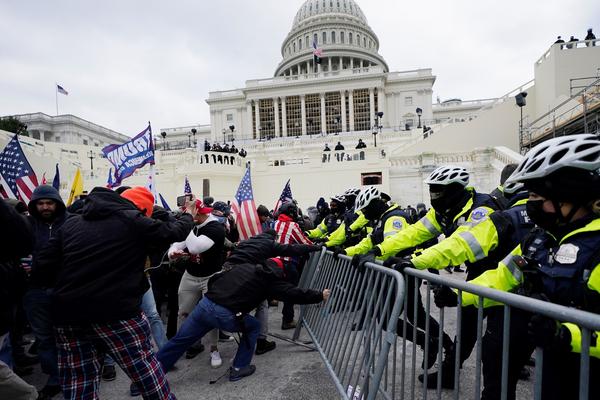 In this Wednesday, Jan. 6, 2021 file photo, Trump supporters try to break through a police barrier at the Capitol in Washington, D.C.