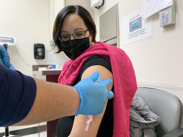 Amanda Bordeaux, 36, gets her second dose of the Pfizer vaccine during a weekly mass vaccination clinic at the Rosebud hospital in South Dakota.