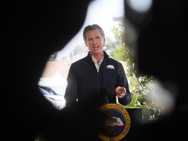 California Governor Gavin Newsom speaks at a press conference following the opening of a new large scale COVID-19 vaccination site in Los Angeles on Tuesday. Newsom says the state will start setting aside 10% of its vaccine allotment for teachers, day care workers and other school employees.