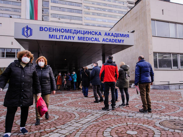 People wait in front of the hospital of the Military Medical Academy in Sofia, Bulgaria, on Feb. 21 for a COVID-19 vaccination.