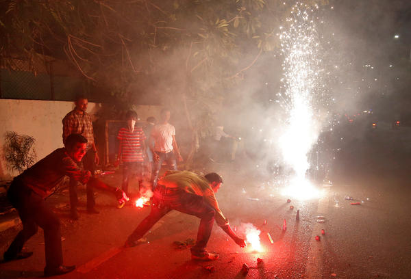 The fireworks of Diwali, the Hindu festival of lights, add smoke to the already polluted skies — and raise concerns about the impact of all that pollution on coronavirus cases. Here, a celebration takes place last year in Ahmedabad, India.