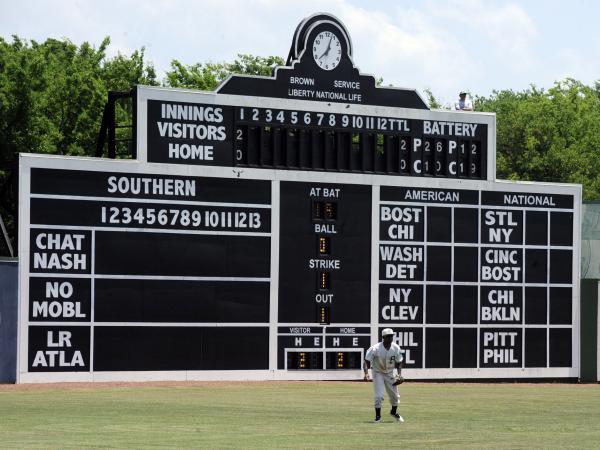 Birmingham Barons outfielder Luis Basabe moves toward a ball in front of the vintage scoreboard in 2019 at Rickwood Field, America's oldest baseball park, in Birmingham, Ala.