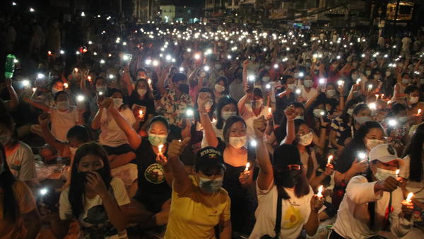 Protesters against last month's military coup hold a candlelight rally in Yangon, Myanmar, on  Saturday. More than 70 people have been killed by security forces since the military overthrew the country's fragile democracy six weeks ago, a United Nations official says.