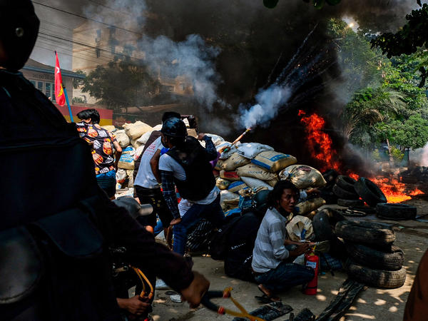 Smoke rises from burning tires on Saturday as demonstrators gather in Thakeyta Township, Yangon, to continue their protest against the military coup in Myanmar.