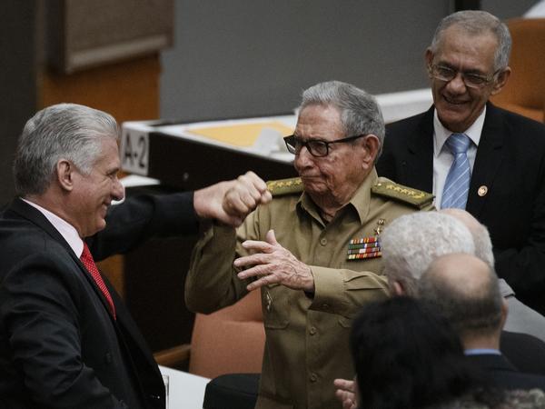 Raúl Castro, first secretary of the Cuban Communist Party and the country's former president, clasps hands with Cuban President Miguel Mario Díaz-Canel Bermúdez during the closing session at the National Assembly of Popular Power in 2019 in Havana.