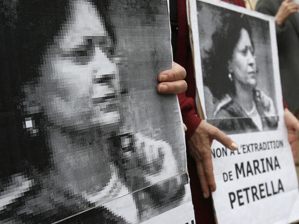 In 2008, people hold portraits of Marina Petrella, a former member of Italy's disbanded Red Brigades group, during a rally in Paris against her extradition to Italy. Petrella is one of seven individuals whose arrest in France was announced Wednesday.