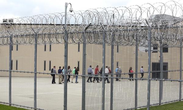 People walk on a tour of the State Correctional Institution at Phoenix in Collegeville, Pa., in 2018. Two brothers who were at the facility have been freed by clemency after expecting to spend their lives incarcerated.