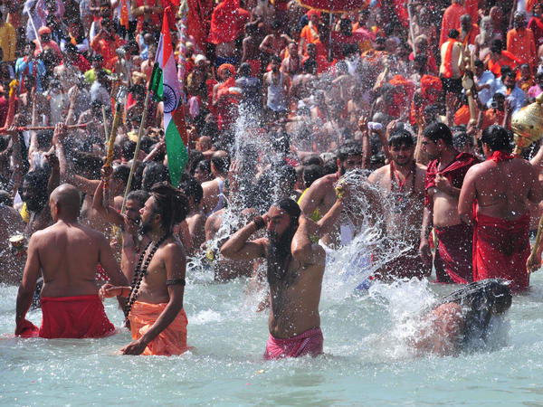 Men take a holy dip in the Ganges River on the occasion of first royal bath of Shivratri festival during Maha Kumbh Festival in Haridwar, India.