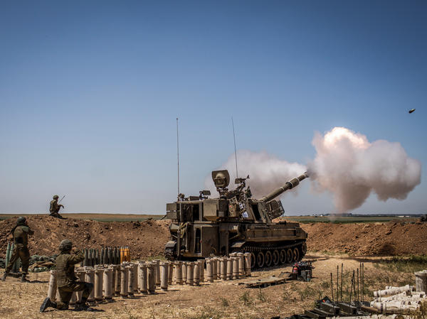 Israeli artillery fires toward the Gaza Strip from a position at the Israeli-Gaza border near Sderot on Wednesday.