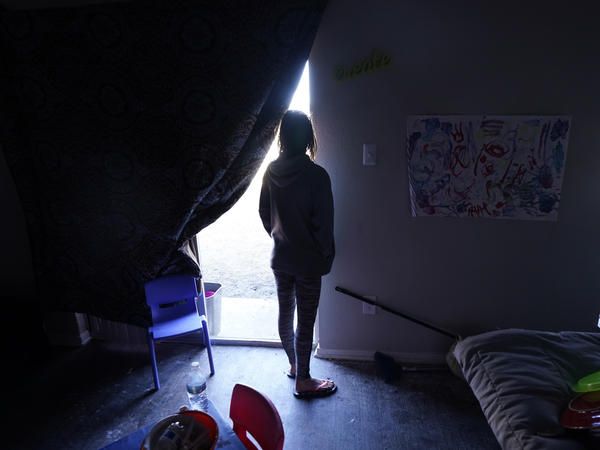 In February, Ricki Mills watches from her Dallas home as she waits for a fire hydrant to be turned on to get water. Texas lawmakers approved a package of measures aimed at addressing what went wrong during one of the worst power outages in U.S. history.