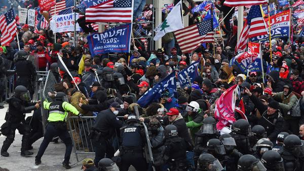 Rioters clash with police as they push barricades to storm the U.S. Capitol on Jan. 6, 2021.