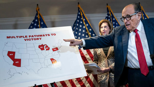 Rudy Giuliani points to a map as he speaks to the press about various lawsuits related to the 2020 election on Nov. 19, 2020. He and other Trump lawyers are now under scrutiny for their roles in promoting false claims of election fraud.