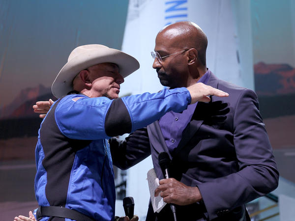 Jeff Bezos hugs Van Jones, founder of Dream Corps, on Tuesday after announcing a $200 million award to him and chef José Andrés for charities of their choice.