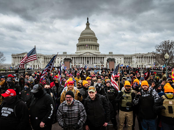 Pro-Trump rioters, including members of the far-right extremist group the Proud Boys, gather near the U.S. Capitol on Jan. 6. At least 25 people charged in the attack appear to have links to the Proud Boys, according to court documents.
