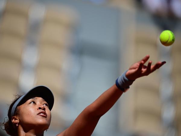 Japan's Naomi Osaka eyes the ball as she serves during the first round of the French Open tennis tournament Sunday in Paris.