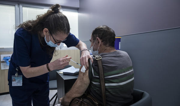 A man receives the Pfizer COVID vaccine in Ramat Gan, Israel. A small Israeli study suggests vaccinated people who experience rare breakthrough infections may develop symptoms that last as long as six weeks.