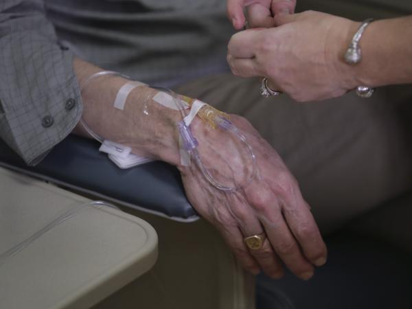 As part of a clinical study, a patient with Alzheimer's disease receives an infusion of aducanumab at a Providence, R.I., hospital in 2019. Aducanumab is being marketed as Aduhelm.