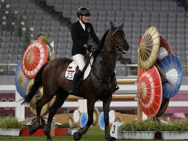 Annika Schleu of Germany cries after failing to control her horse while competing in the equestrian portion of the women's modern pentathlon at the 2020 Summer Olympics on Friday.