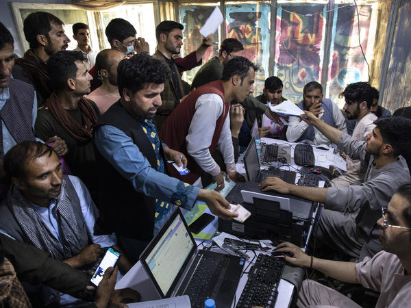 Afghan special immigrant visa applicants crowd into an internet cafe to apply for that program on Aug. 8 in Kabul. A group of senators expressed concern the U.S. is abandoning allies who helped in the 20-year mission in Afghanistan.