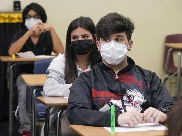 Students sit in an algebra class at Barbara Coleman Senior High School on the first day of school on Monday in Miami Lakes, Fla. Miami-Dade County public schools require students to wear a mask to prevent the spread of COVID-19.