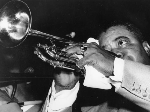 American jazz musician Louis Armstrong plays his trumpet during a performance with his band in Stockholm, Sweden in Oct. 1952. The Karnofsky Shop in New Orleans, which made a lasting impact on his musical legacy, was destroyed by Hurricane Ida in August 2021.