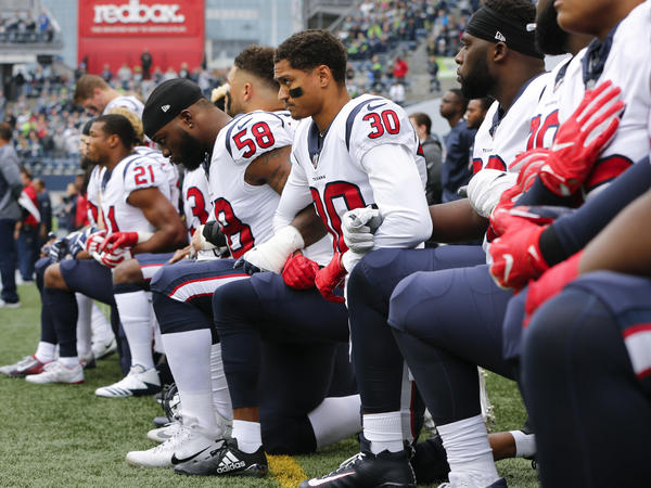 Members of the Houston Texans kneel during the national anthem before the game at CenturyLink Field on Oct. 29, 2017 in Seattle.