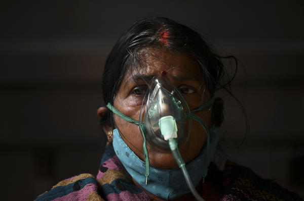 A patient breathes with the help of oxygen provided at a tent installed at a gurdwara, a place of worship for Sikhs, in Ghaziabad, India, on May 2.