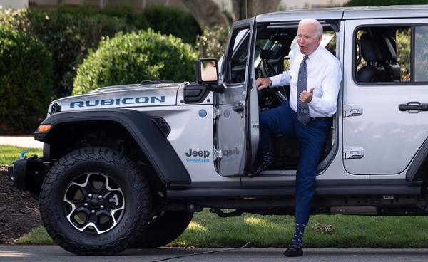 President Biden gets out of a Jeep Wrangler Rubicon 4xE after delivering remarks at the White House Thursday on electric vehicles and new fuel economy and emissions standards.