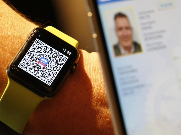 A person scans a QR Code on an Apple Watch to send a digital driver's license temporarily to another mobile phone last month in Salt Lake City. Utah is among eight states that eventually will let users add a license or state ID to Apple Wallet.
