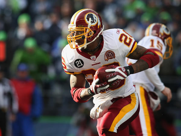 Former Washington Football Team running back Clinton Portis carries the ball during an NFL wildcard playoff football game against the Seattle Seahawks in Jan. 2008. Portis plead guilty to health care fraud charges Tuesday, authorities said.