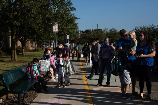 Parents drop their children off for the first day of school in Novi, Mich., on Tuesday.