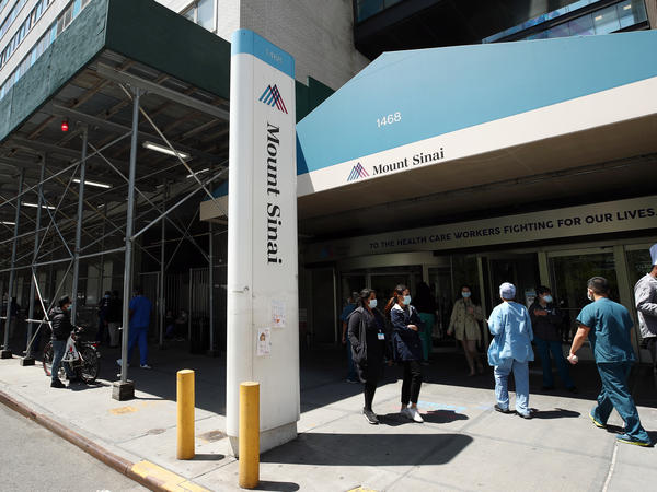 A view of the entrance to Mount Sinai Hospital in New York City on May 14, 2020. Hospital and nursing home workers across New York are required to have at least one dose of a COVID-19 vaccine by Monday, prompting concerns over noncompliance and potential staffing shortages.