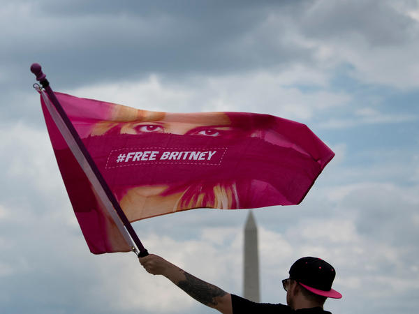 A man waves a "Free Britney" flag during a July 14 rally in front of the Lincoln Memorial in Washington, D.C., protesting the conservatorship of Britney Spears.