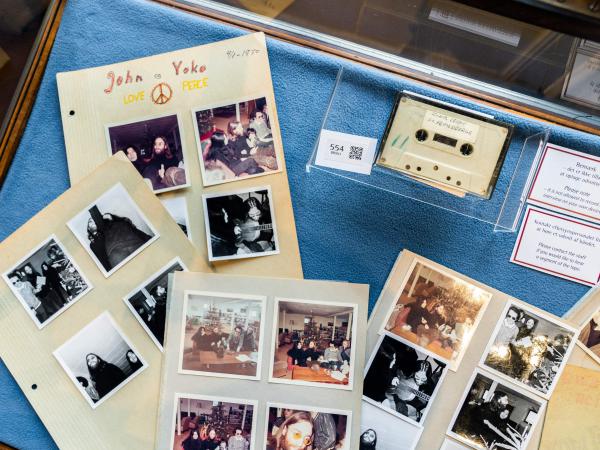 A cassette with the recording of teenage journalists' 1970 interview with John Lennon and Yoko Ono, along with polaroid photos from the conversation, seen at Bruun Rasmussen Auction House in Copenhagen on September 24, 2021. An unidentified bidder won the lot for the equivalent of $58,240.
