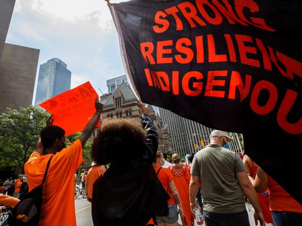 People march during the Every Child Matters walk in honor of children who lost their lives in Canada's Residential School system, in Toronto, Canada, on July 1.