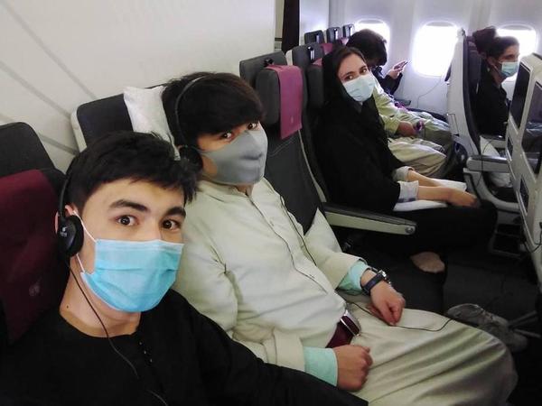 Members of the Afghanistan National Institute of Music on the plane to Doha.