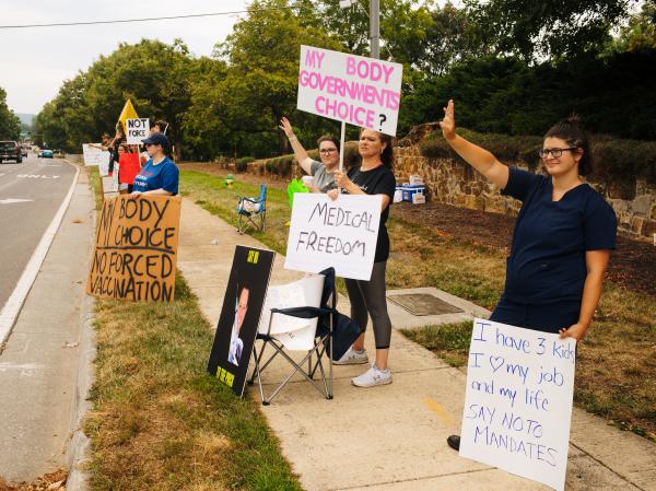 Brittany Watson, Katherine Hart, Dawn Carlisle and Amanda Mackanos protest vaccine mandates outside Winchester Medical Center in August in Winchester, Va.