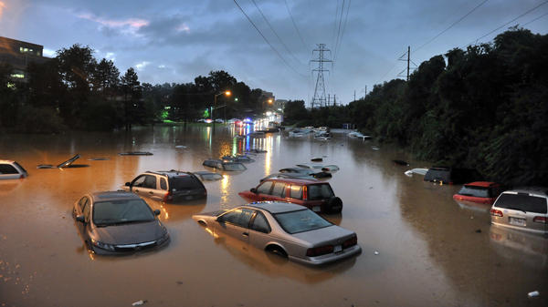 Scenes after heavy rainfall flooded a commuter parking lot in Reston, VA with some cars completely submerged.