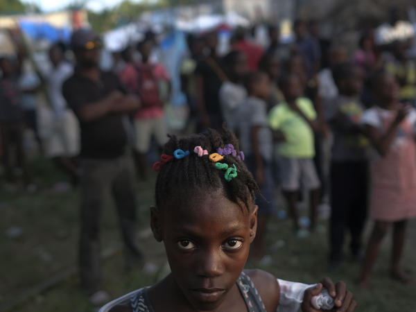 A girl waits with other earthquake victims for the start of a food distribution in Les Cayes, Haiti, in August, a week after a 7.2 magnitude earthquake hit the area.
