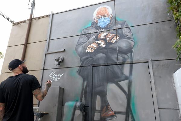 Artist Jonas Never (@never1959) applies finishing touches to his mural of Sen. Bernie Sanders in Culver City, Calif., on Jan. 24. Standing out in a crowd of glamorously dressed guests, Sanders showed up for the presidential inauguration in a heavy winter jacket and patterned mittens — with an AFP photo of the veteran leftist spawning the first viral meme of the Biden era.