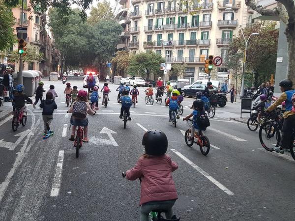 Children joining the <em>bicibús</em> in the Eixample district of Barcelona, Spain, make their way to school on a recent Friday morning. The community is hoping to build a school-friendly bike lane for a safer commute for kids.