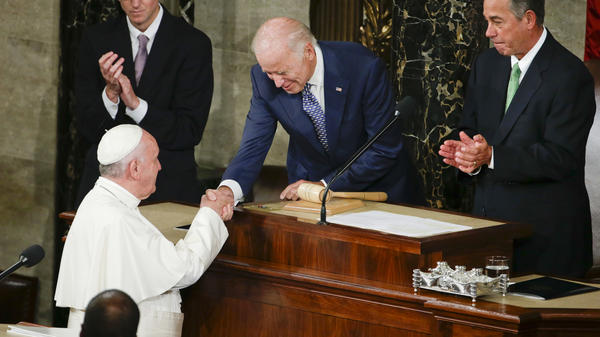 Then-Vice President Biden shakes hands with Pope Francis on Capitol Hill in Washington, prior to the pope's address to a joint meeting of Congress in 2015. On Friday, Francis will welcome Biden to the Vatican for the first time since Biden took office, becoming the second Catholic president in U.S. history.