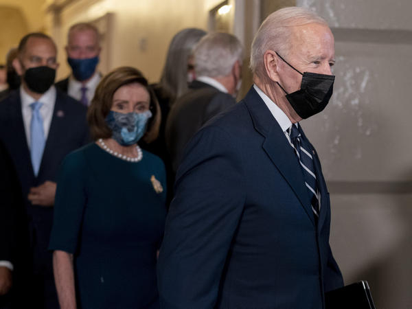President Biden, accompanied by House Speaker Nancy Pelosi (second from left) and Rep. Hakeem Jeffries, D-N.Y., (left) arrives to meet with House Democrats at the Capitol on Thursday.