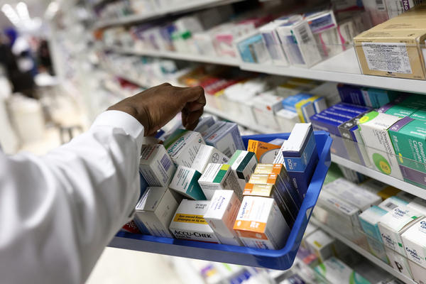 A pharmacist collects packets of boxed medication from the shelves of a pharmacy in London, U.K. A proposal announced by House Speaker Nancy Pelosi Thursday would allow the government to directly negotiate the price of 250 U.S. drugs, using what the drugs cost in Australia, Canada, France, Germany, Japan, and the United Kingdom as a baseline.