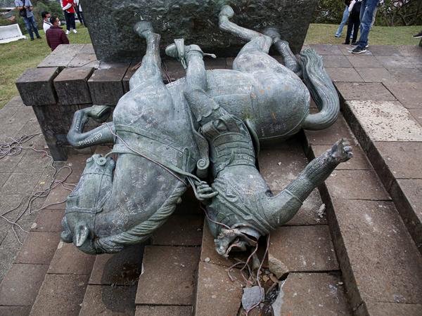 The statue of Sebastián de Belalcázar, a 16th century Spanish conquistador, lies on the ground after it was pulled down by Indigenous people in Popayán, Colombia, earlier this year.