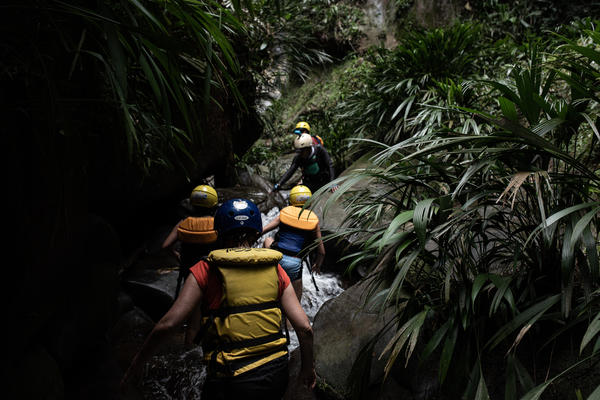 While rafting down the Guejar River, tourists stop to hike along a stream to a waterfall near the town of Mesetas, which used to be under FARC rebel control in southern Colombia.